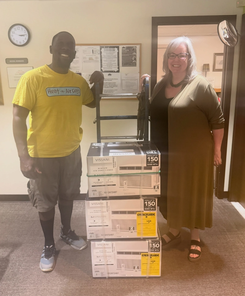 Cavon Bennett of Heat-N-Air Guys and Renee Cunningham of Center in the Park with donated window air conditioners